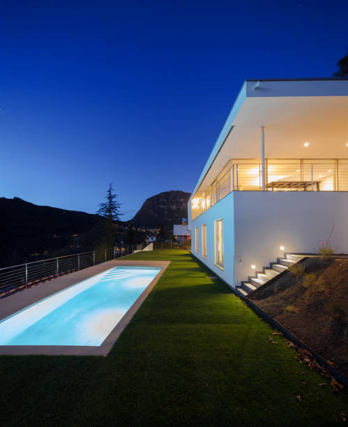 Modern house, exterior in the night, lights on